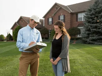 Lawn Doctor technician reviewing a lawn plan with a homeowner